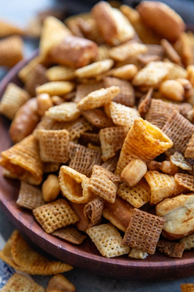 wooden plate full of chex mix
