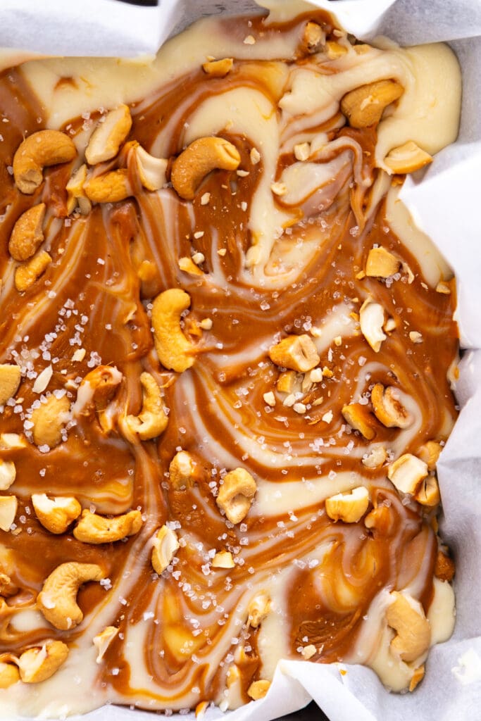 white chocolate fudge with caramel and cashews swirl in pan