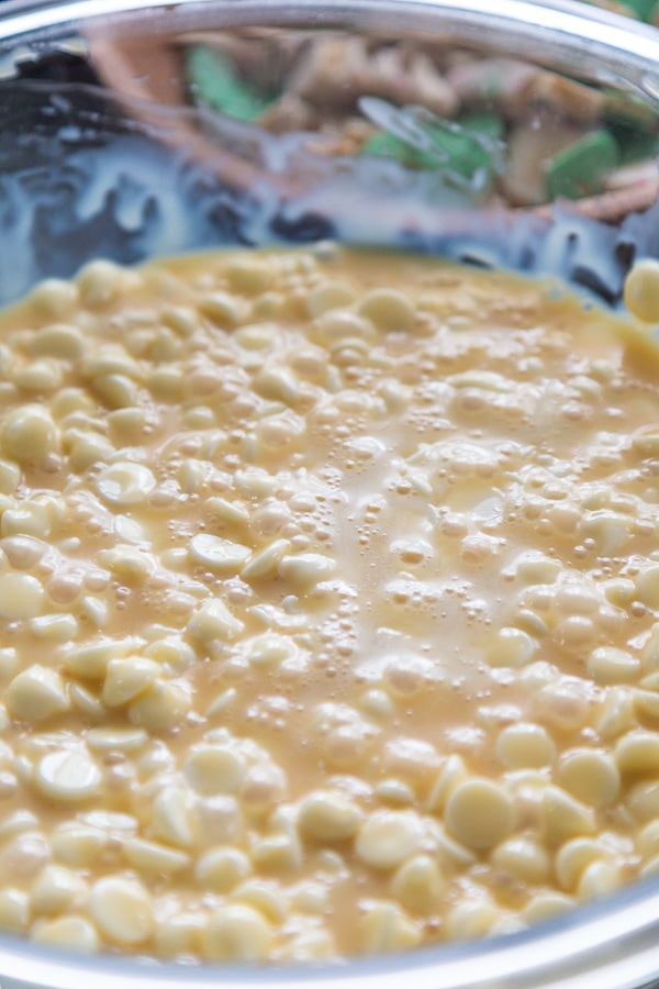 white chocolate chips with heavy cream and sweetened condensed milk in boxing bowl