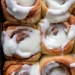 overhead shot of cinnamon rolls in pan froster
