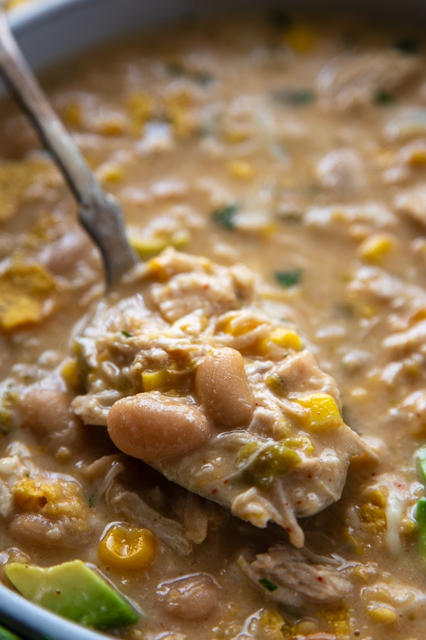close-up shot of white chicken chili on spoon