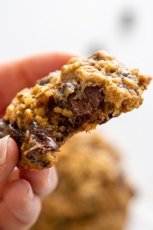 chocolate chip cookie made with oatmeal and zucchini with bite out of it