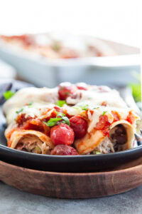 two cherry enchiladas on a plate