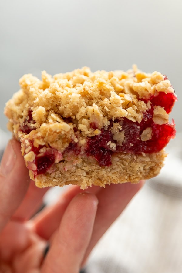 hand holding a cherry oat bar