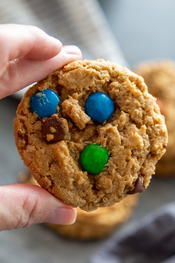 hand holding a single M&M cookie