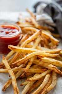 french fries in a bunch with ketchup
