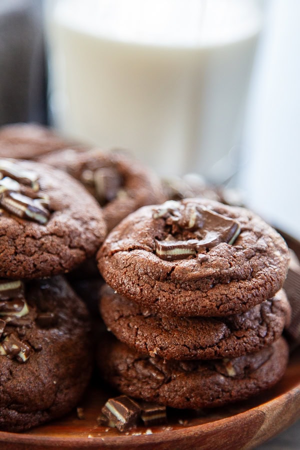 plate of chocolate cookies with mint and cup of milk