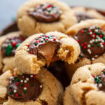 plate of rolo peanut butter blossoms with one cookie having a bite out of it