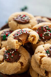 plate of rolo peanut butter blossoms with one cookie having a bite out of it