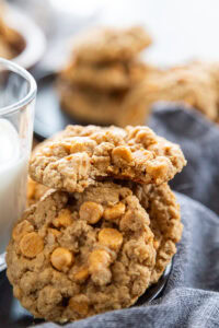 oatmeal peanut butter butterscotch chip cookies in stack with bite out of it