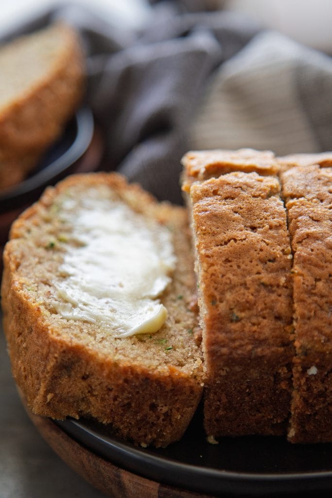 zucchini bread on plate with butter