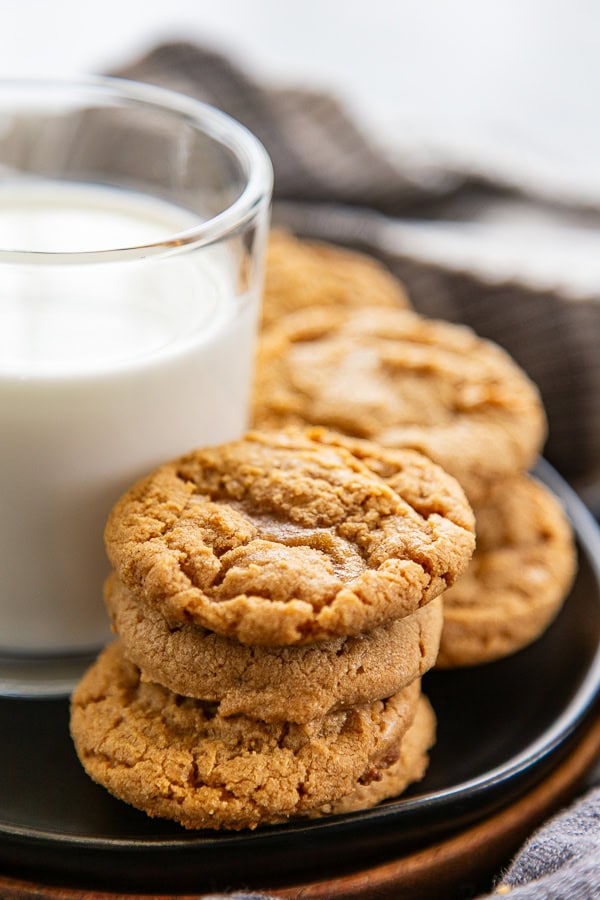 shot of peanut butter cookies next to a cup of milk