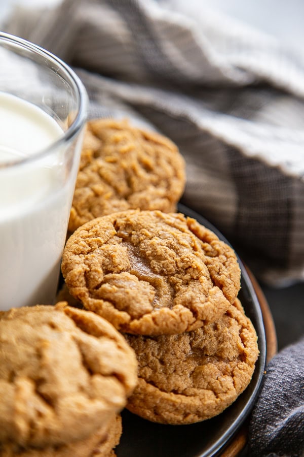 stack of cookies next to a glass of milk