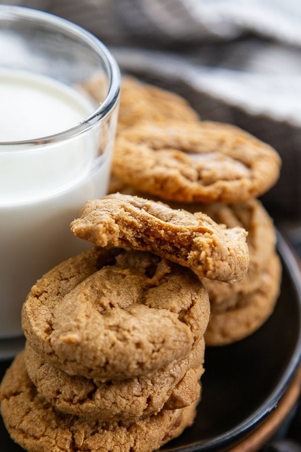 stack of peanut butter cookies with the top one having a bite out of it