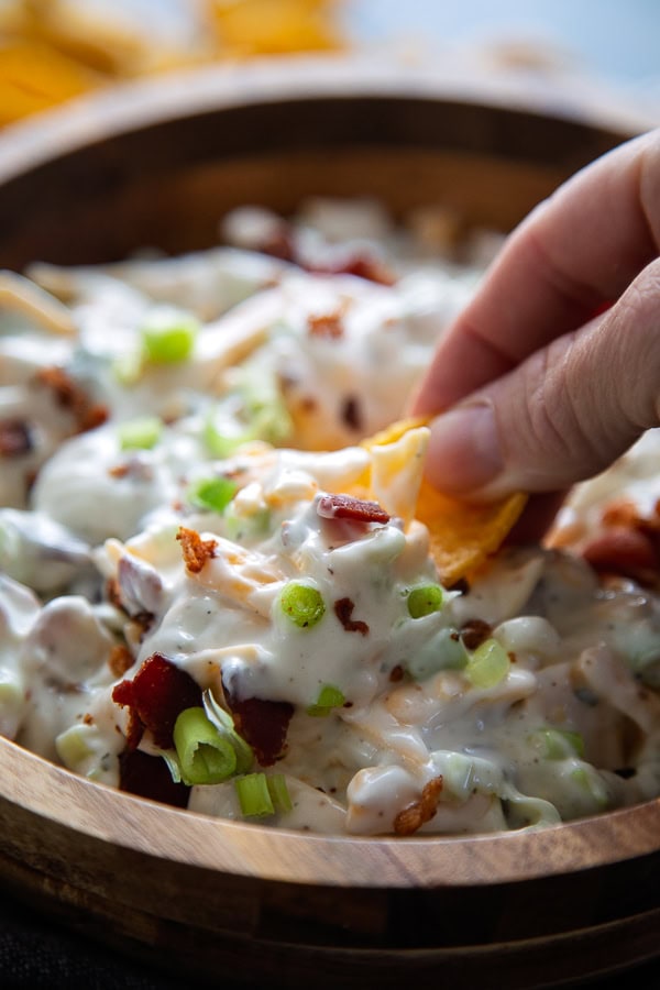 ranch dip in wodden bowl with chip